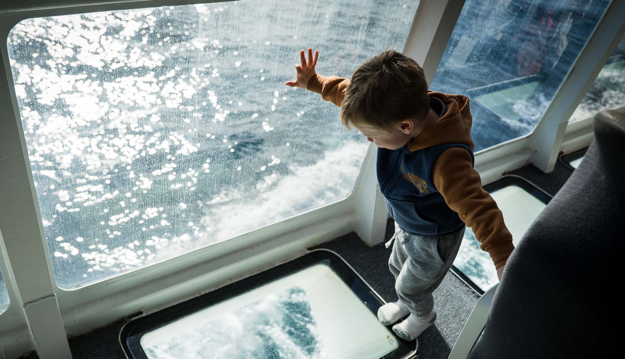 Child looking through the floor windows on Aurora V.